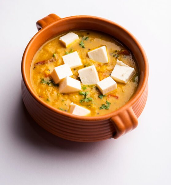 Paneer Dal fry is a combination of cottage cheese cubes dipped in yellow lentil masala. served in a bowl