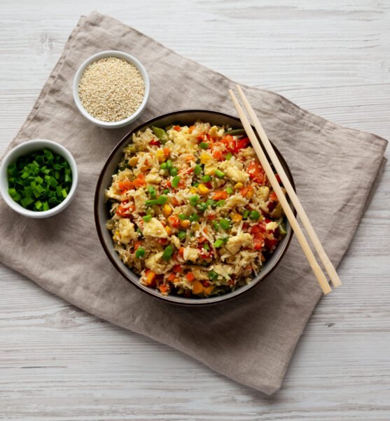 Homemade Cauliflower Fried Rice with Chives and Sesame Seeds in a Bowl, top view. Flat lay, overhead, from above.