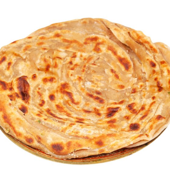 Indian cuisine - lachha paratha (multi layered fried flatbread ) on brass plate isolated on white background