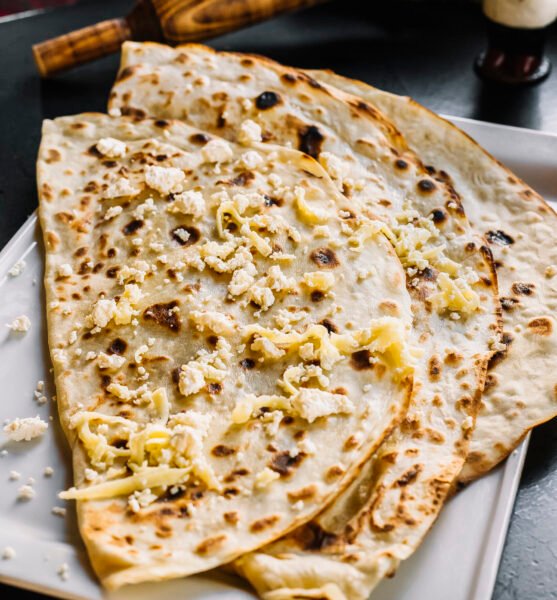 traditional dish meat kutab with grated cheese on the top side view