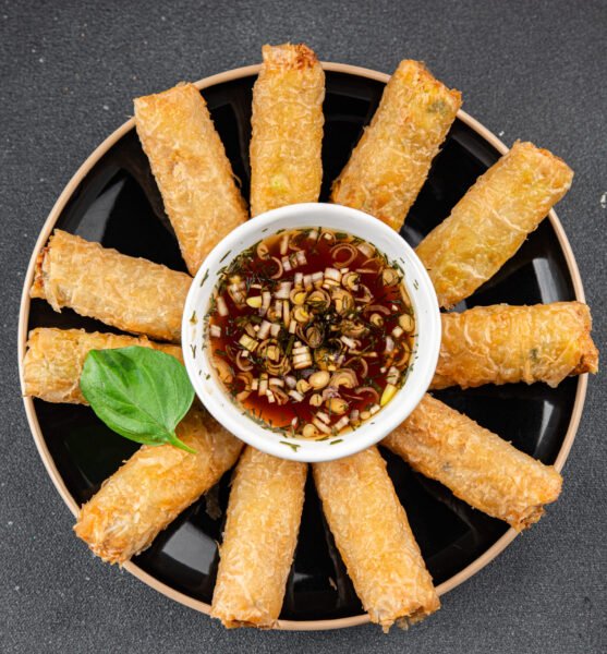 Nem rolls with sauce vietnamese rice paper roll delicious gourmet food background on the table rustic food top view copy space