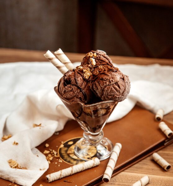 side view chocolate ice cream with nuts and wafer rolls