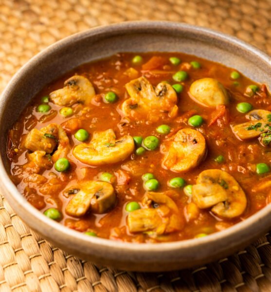 Mushroom and Pea Curry with Roasted Garlic, Indian food served in a bowl