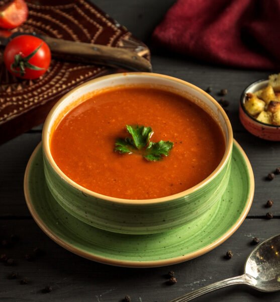 tomato soup with green on the table